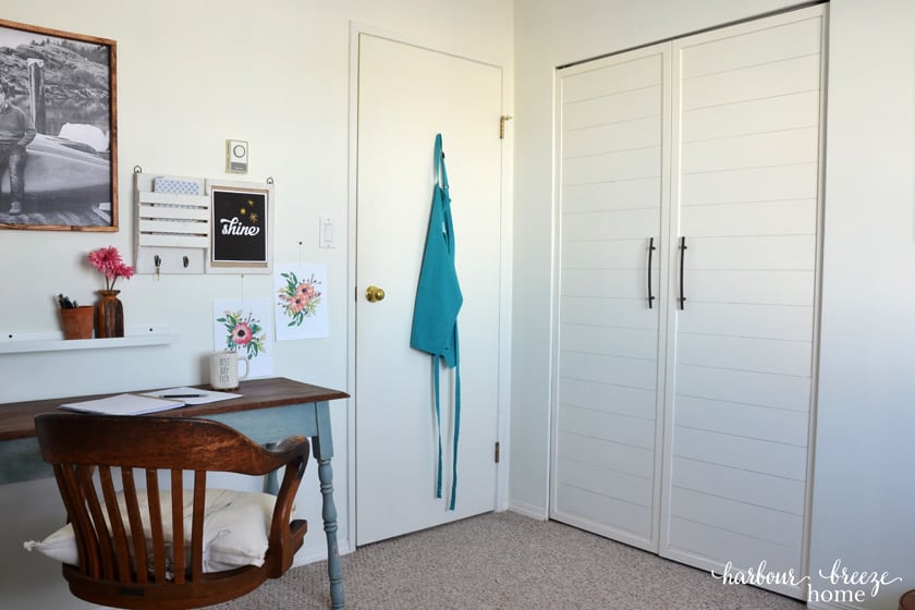Office area with double closet doors beside it.