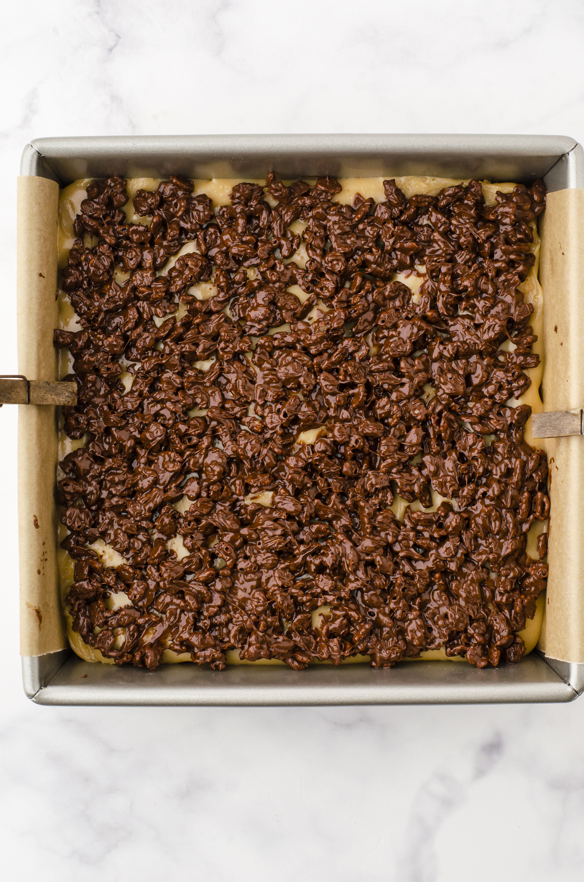 A finished pan of caramel chocolate crispy rice squares.