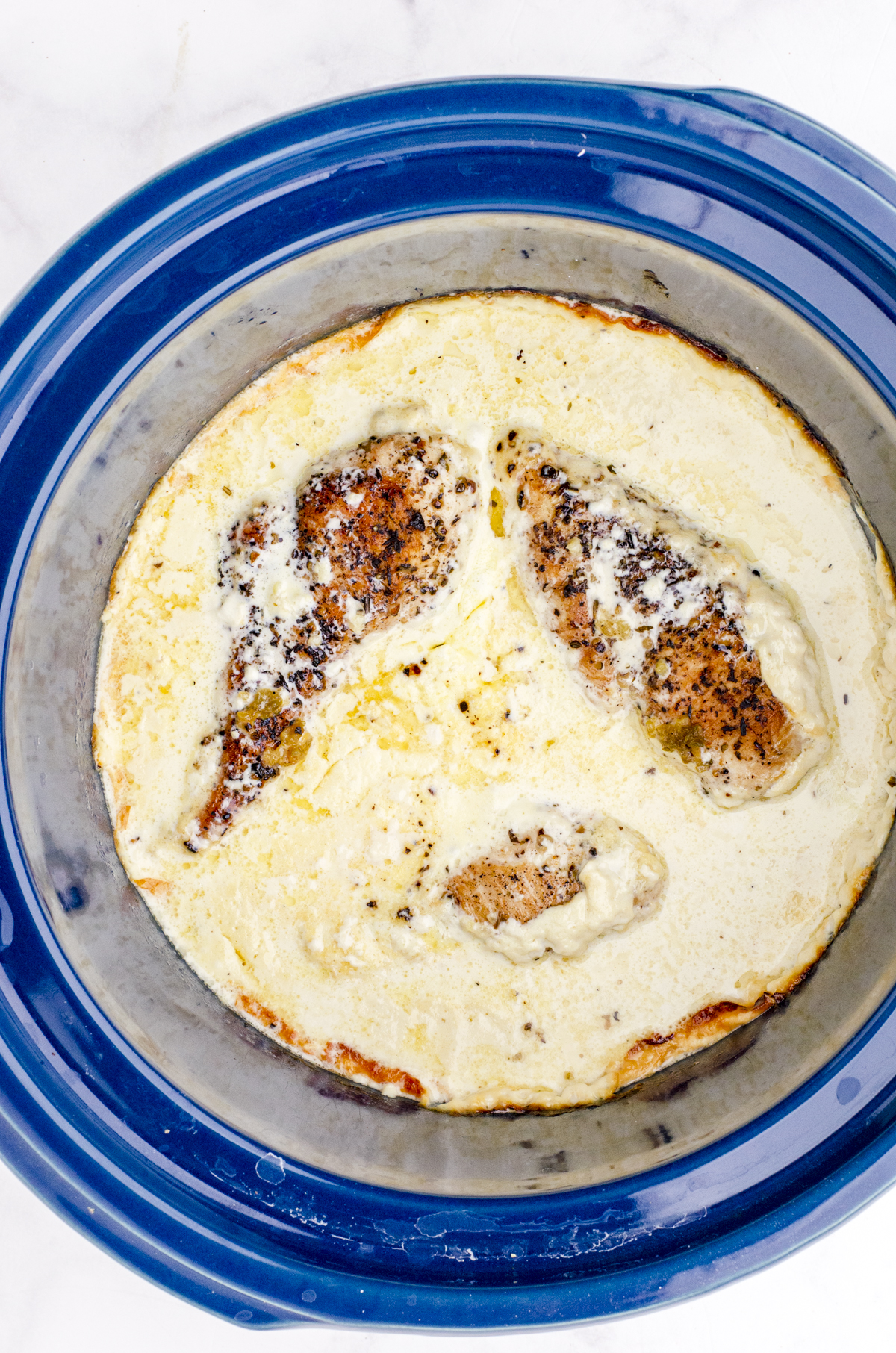 Slow Cooker Chicken Alfredo in a crock pot after it has been cooked.