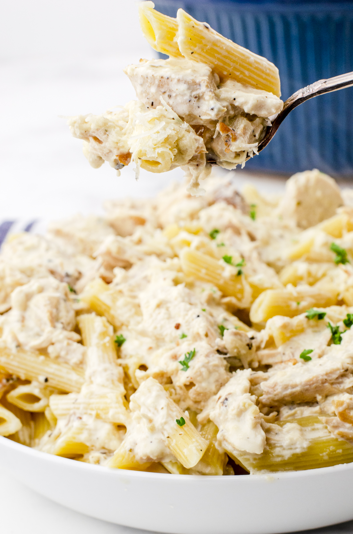 A fork full of crock pot chicken alfredo and pasta