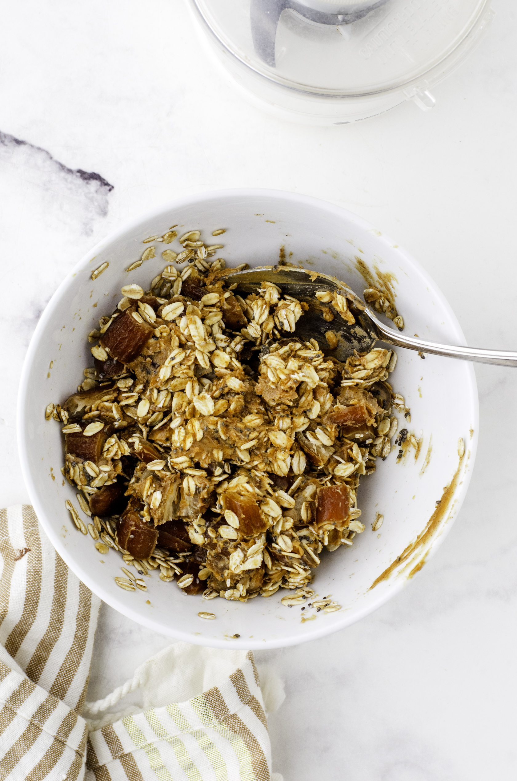 Date ball ingredients being stirred together in a bowl.
