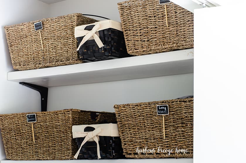 Pretty organization baskets in a closet that has been decluttered.