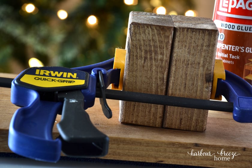 2 blocks of wood with a clamp on them