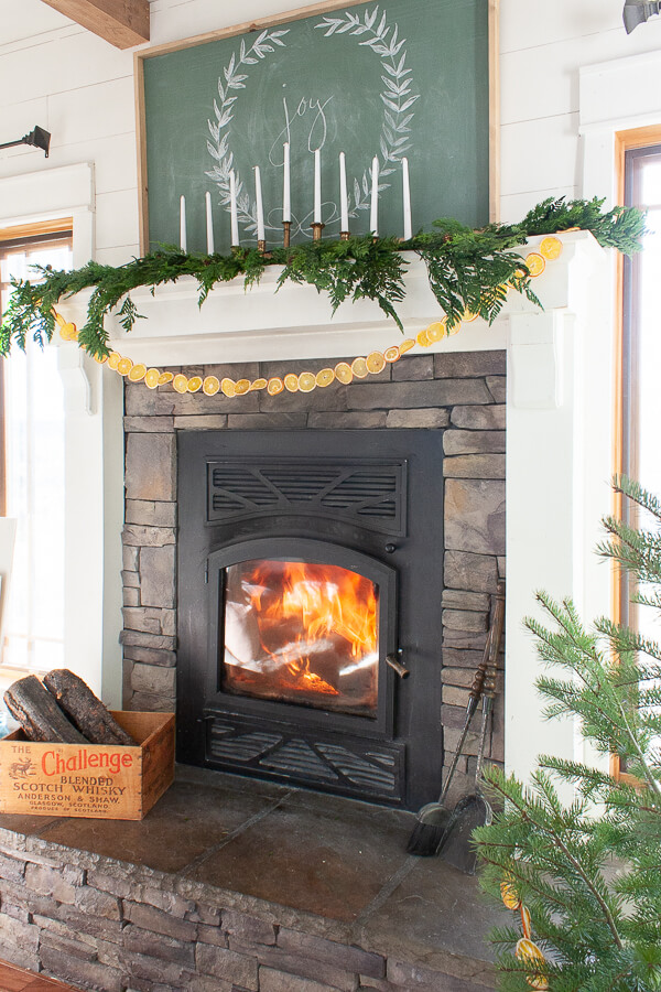 Dried orange slices strung to make a garland and hung on a fireplace mantel