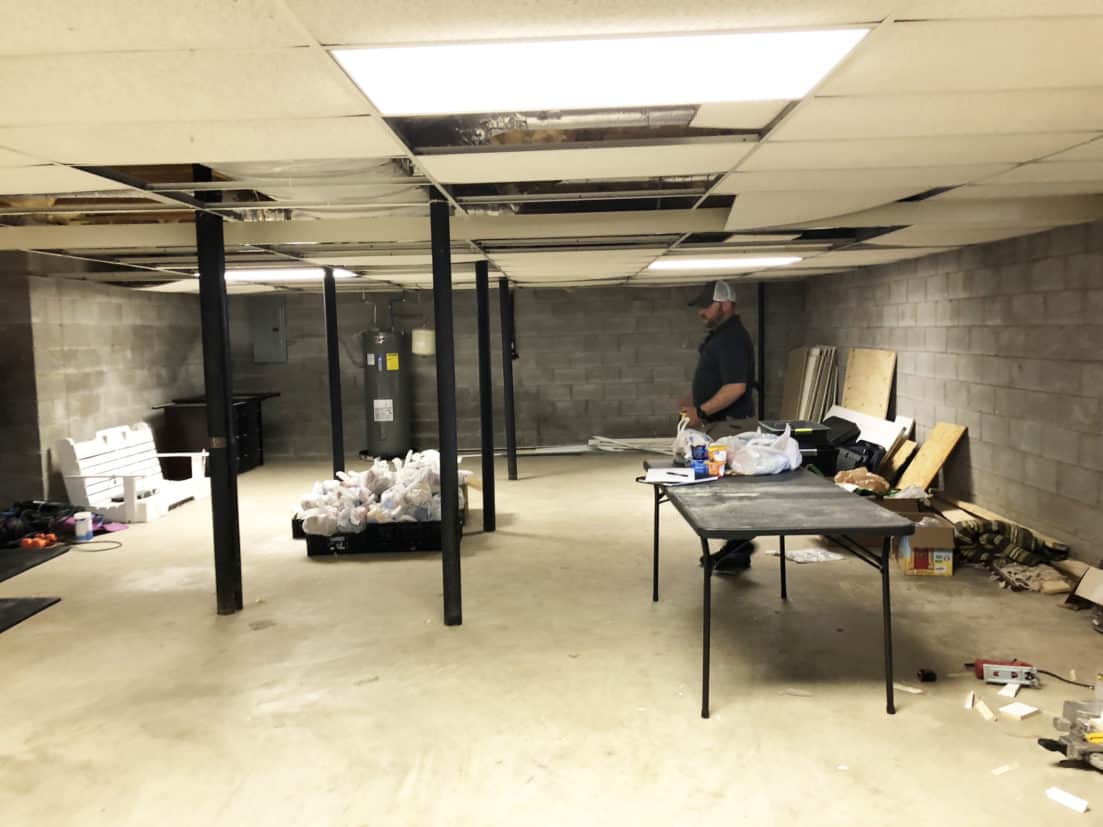 An unfinished basement with black poles in it