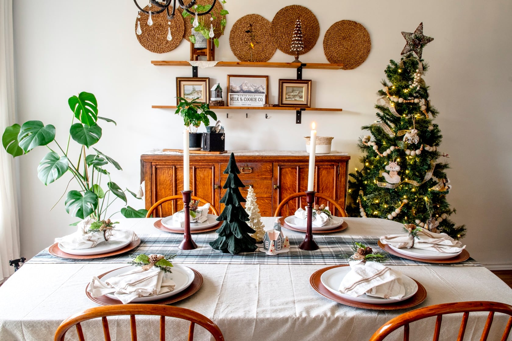 A table set in a dining room with a Christmas tablescape.