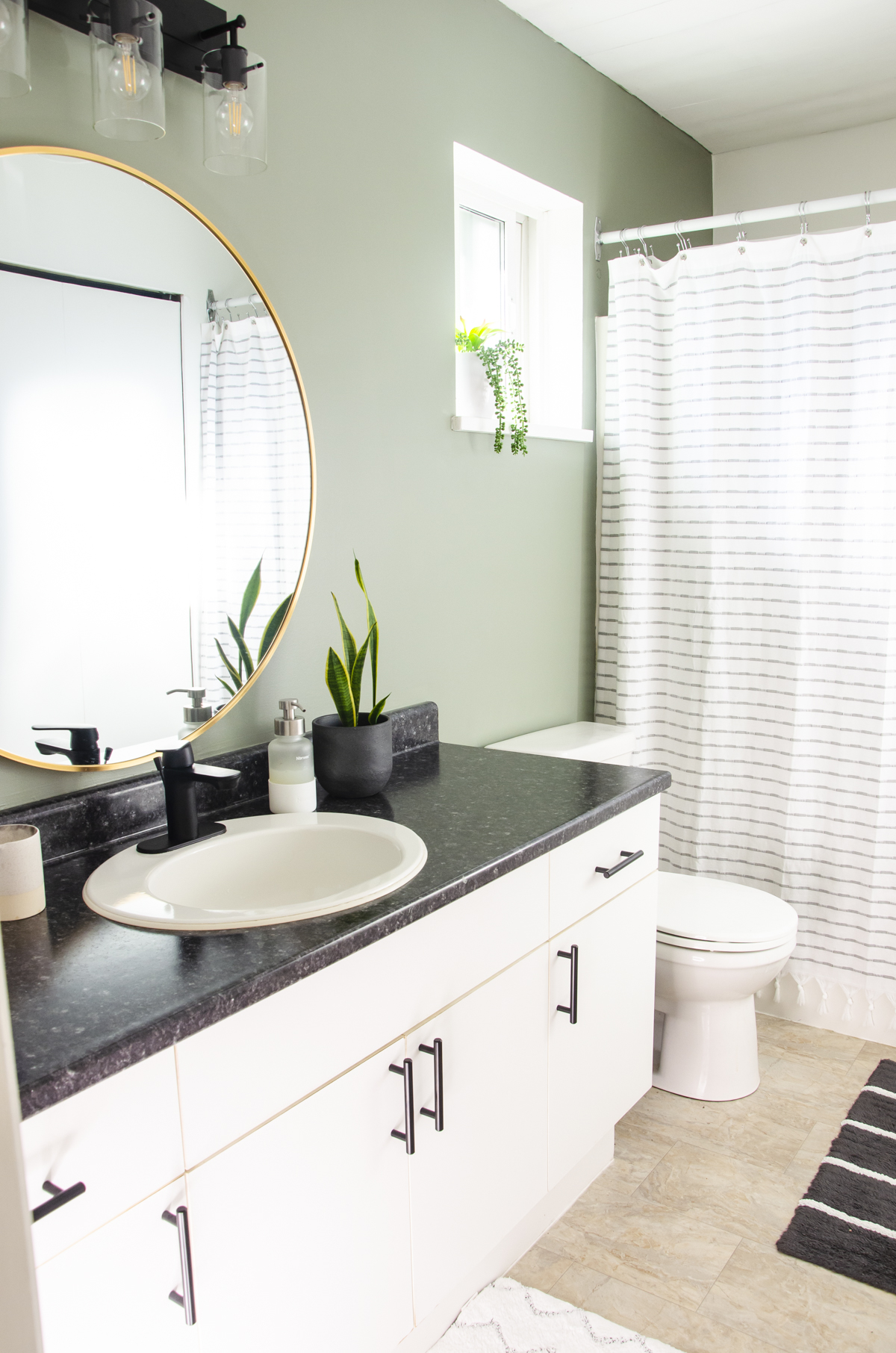 A bathroom painted in the color Evergreen Fog by Sherwin Williams.