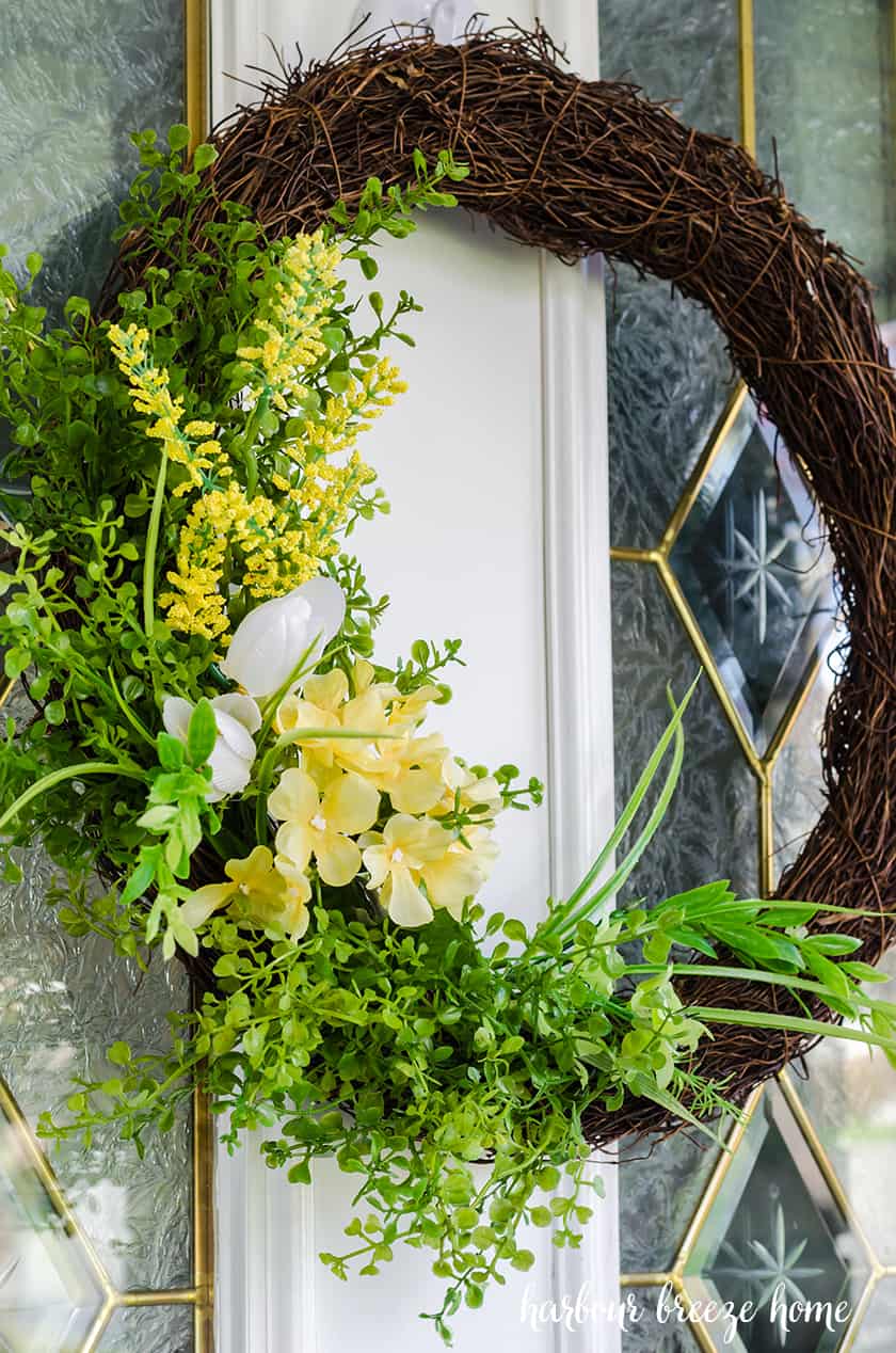 front door wreath with fake yellow flowers for Spring and Summer