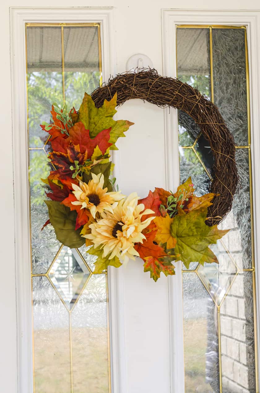 Fall wreath with fake flowers on an exterior front door