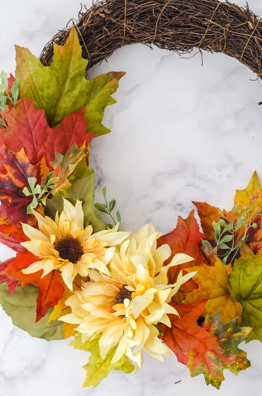 close up of the fake flowers on a fall wreath