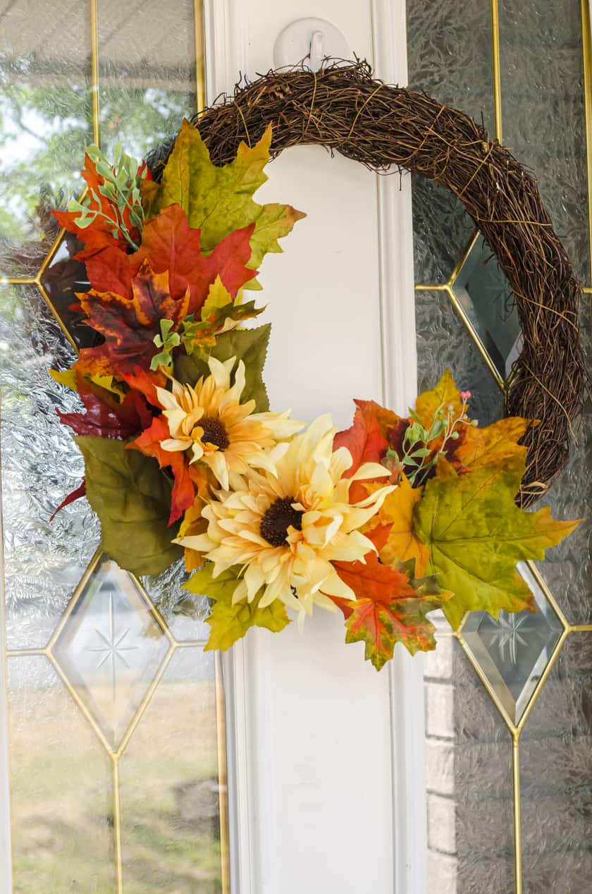 Fall wreath with fake flowers - sunflowers and fake fall leaves on a grapevine wreath base