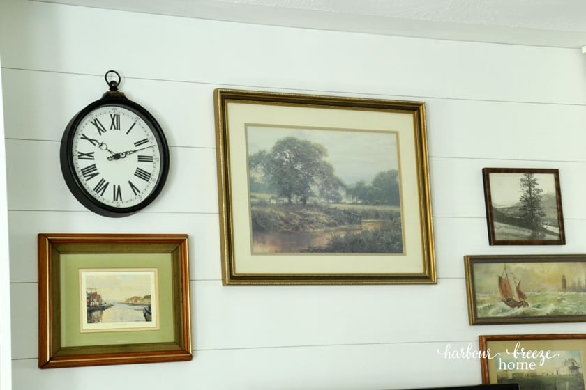 Shiplap wall treatment with vintage art prints
