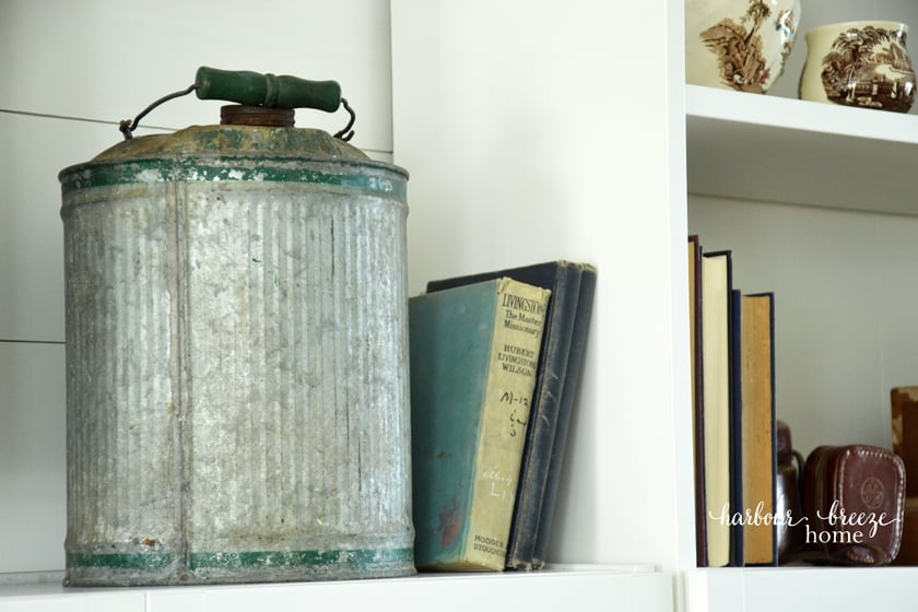 Galvanized metal gas can used as decor for a farmhouse style bookcase