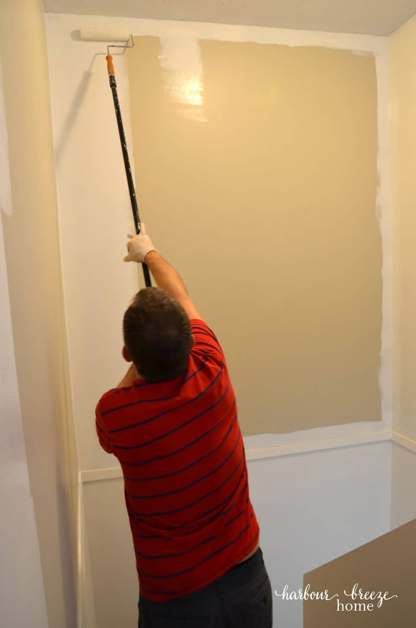 Benjamin Moore Simply White paint being painted in a stairwell