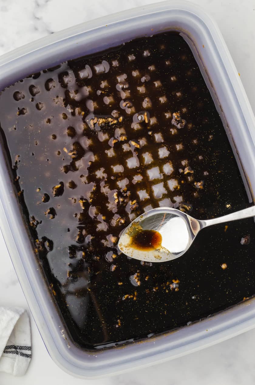 chicken teriakyi marinade being stirred in a tupperware marinade container