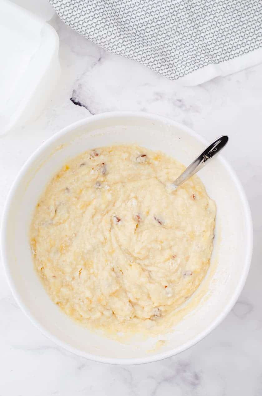 Stir the wet and dry ingredients together in a large mixing bowl for a moist buttermilk banana bread recipe.