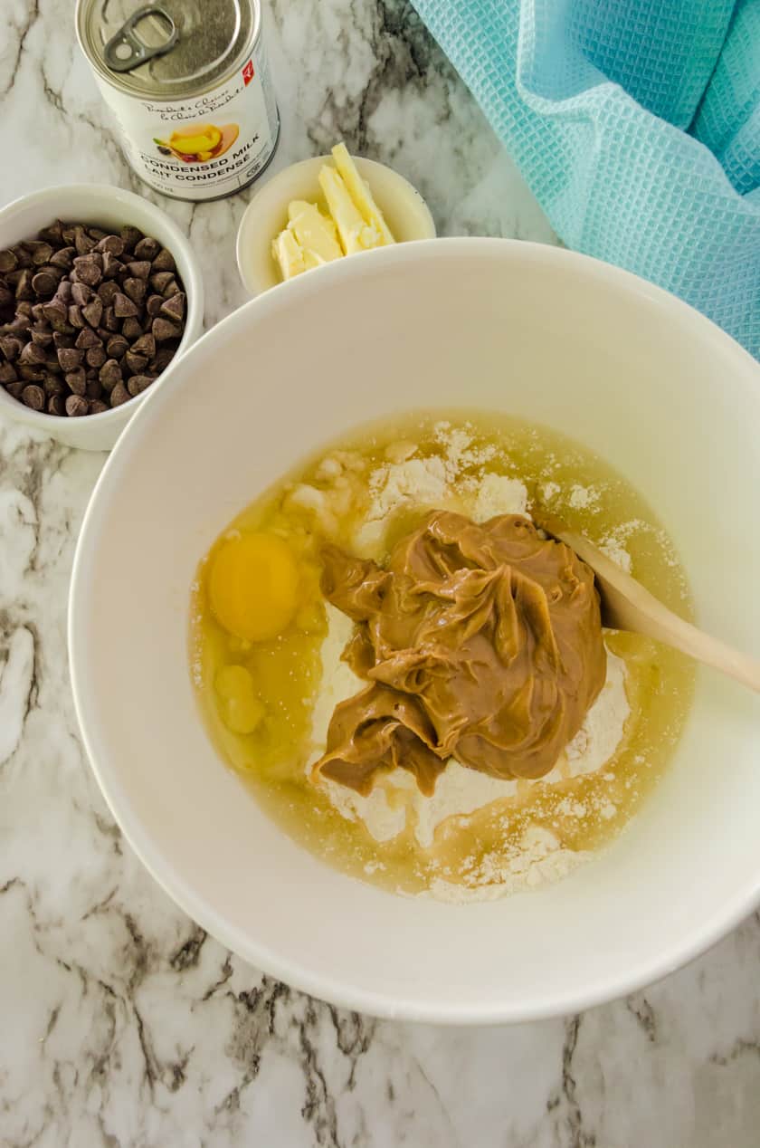 cake mix, egg, and peanut butter in a mixing bowl for peanut butter fudge bars