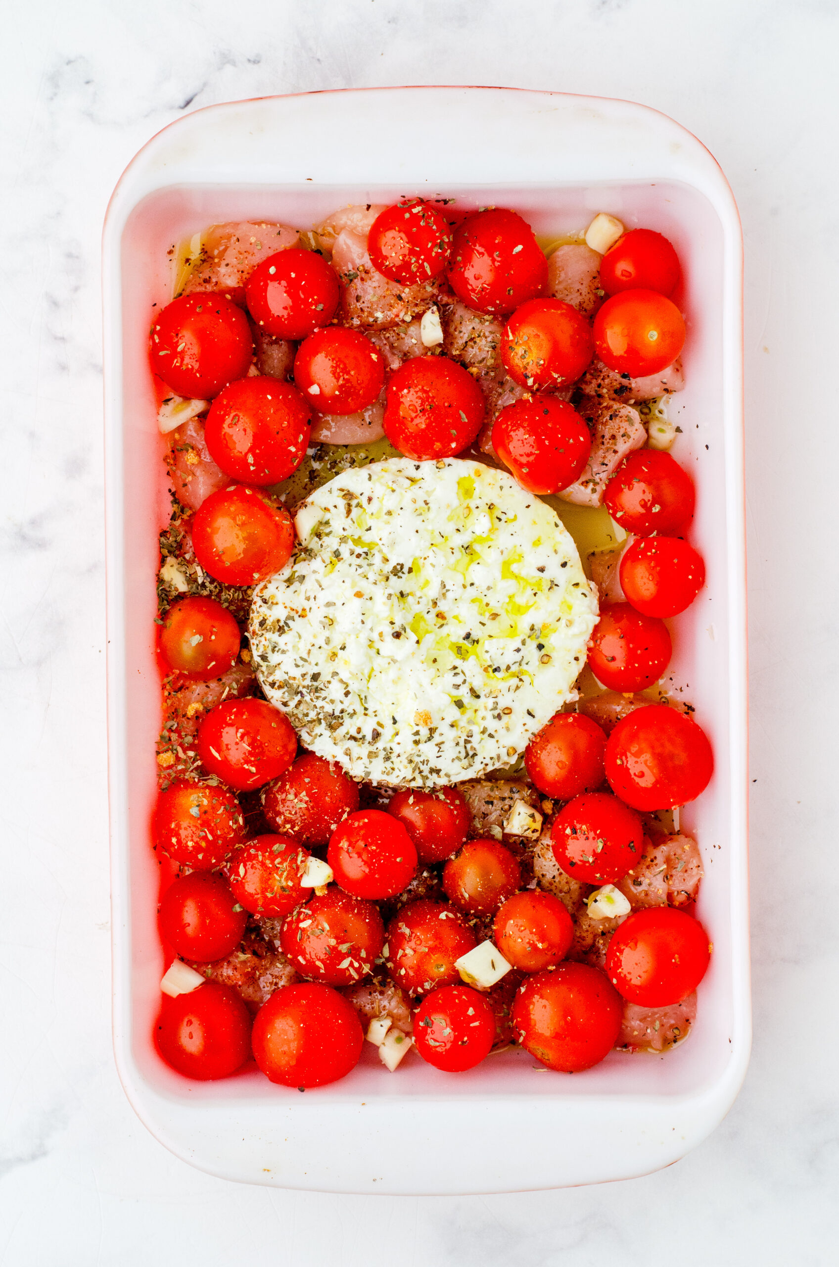 feta chicken pasta ingredients in a baking dish
