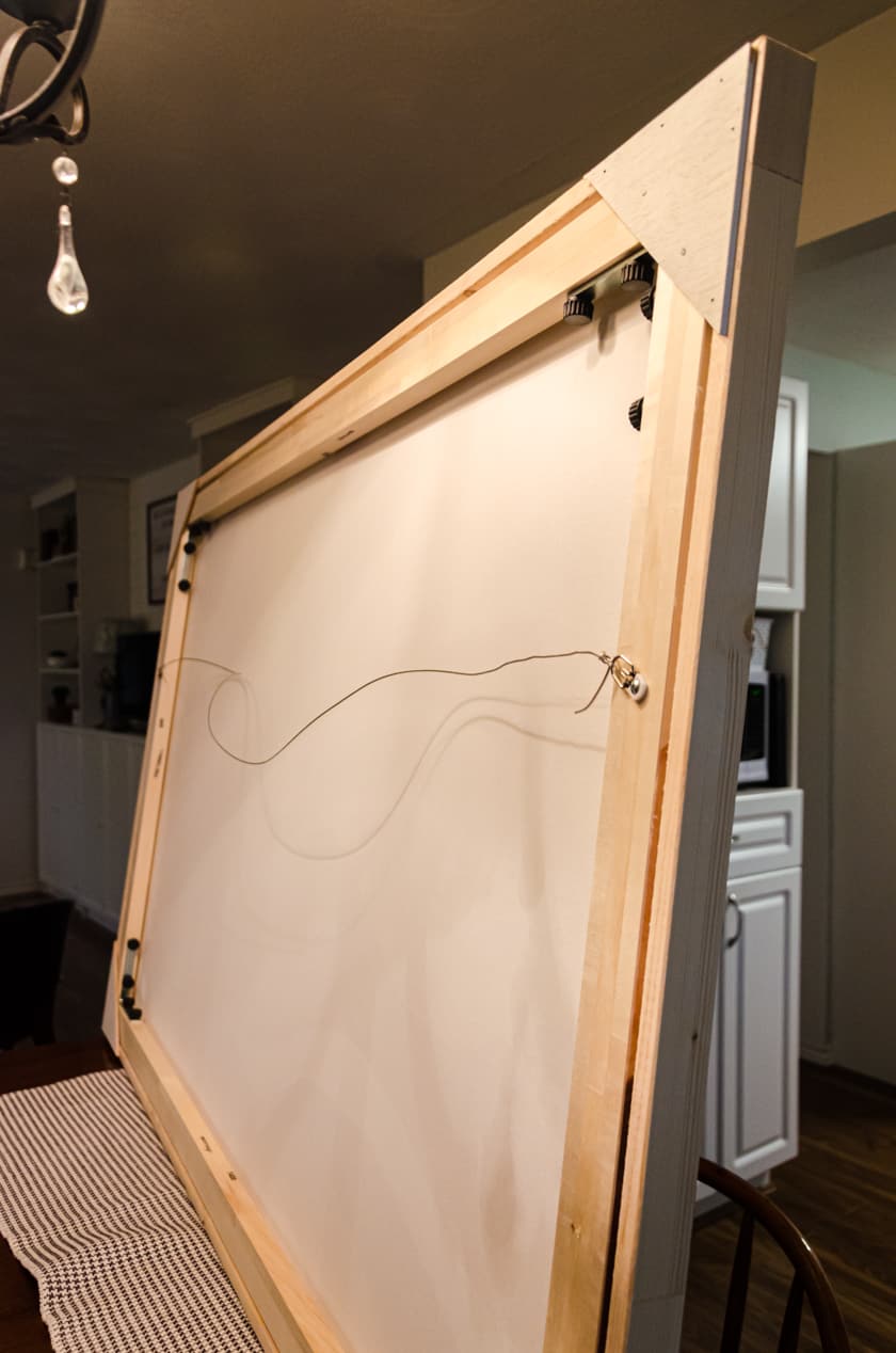 The back side of a large art canvas with floating frame