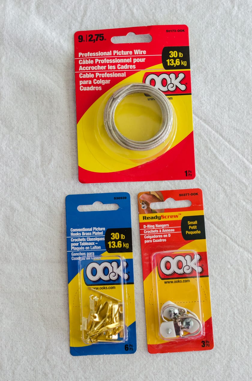 the packages of supplies used to create a sturdy hanging system on the back of a canvas with floating frame