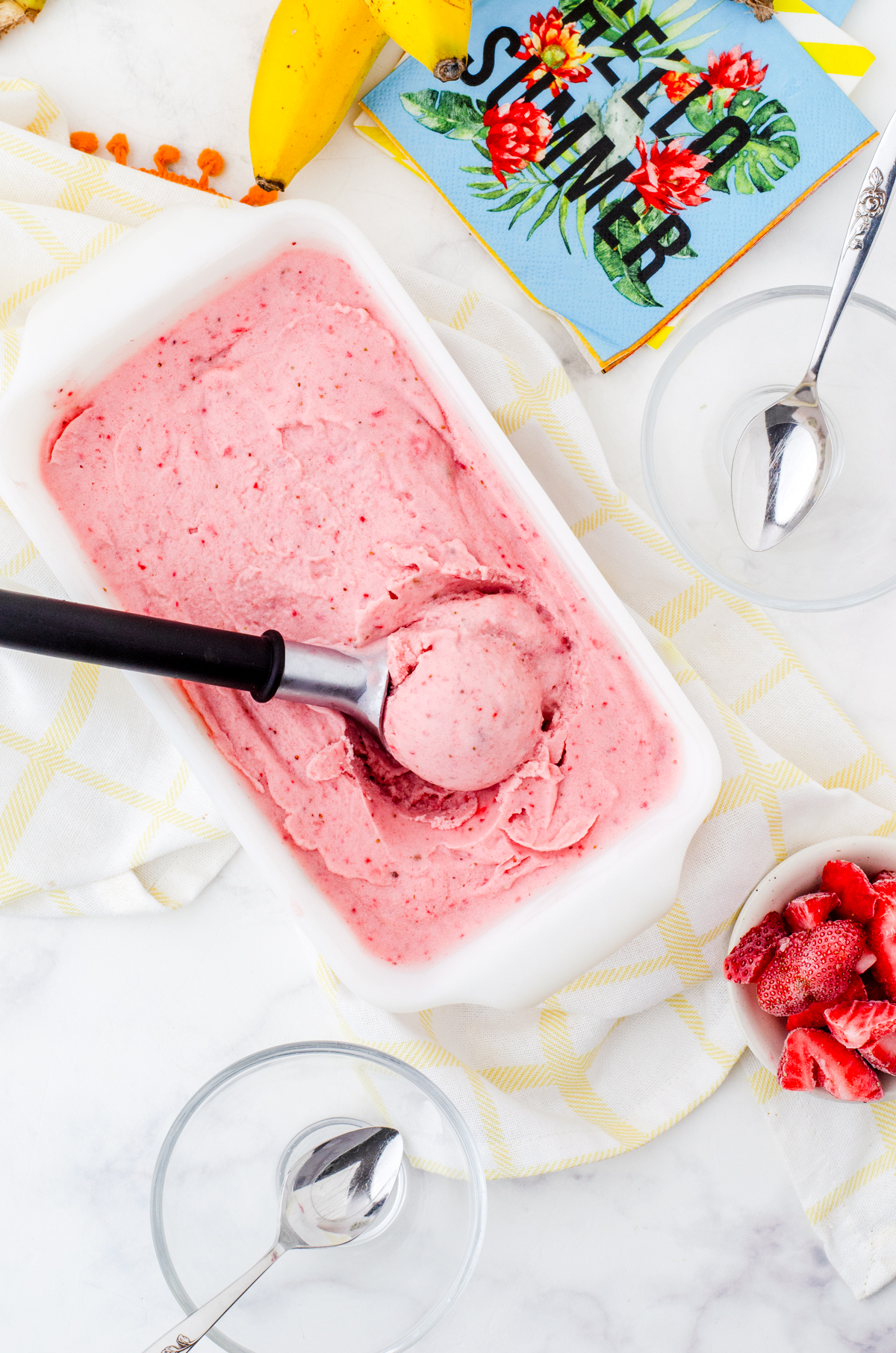 Frozen yogurt being scooped out of a loaf pan