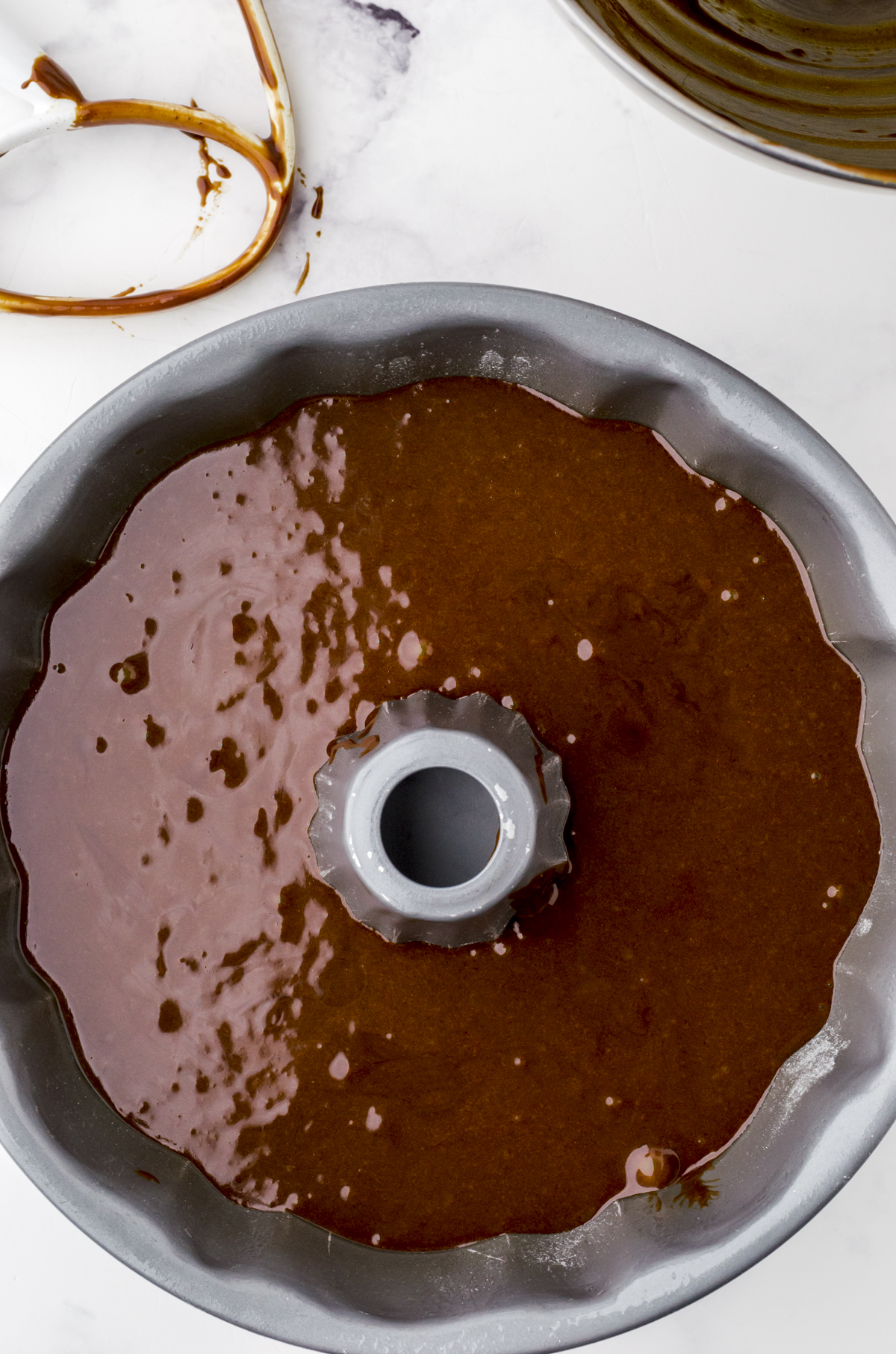 Gingerbread cake batter poured into a bundt pan