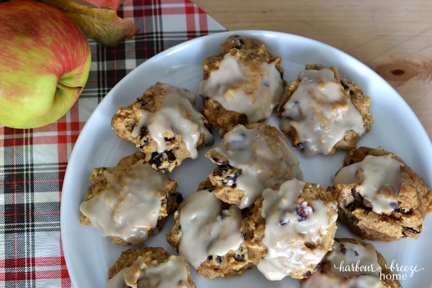 glazed apple cookies on a white plate with a plaid napkin underneath