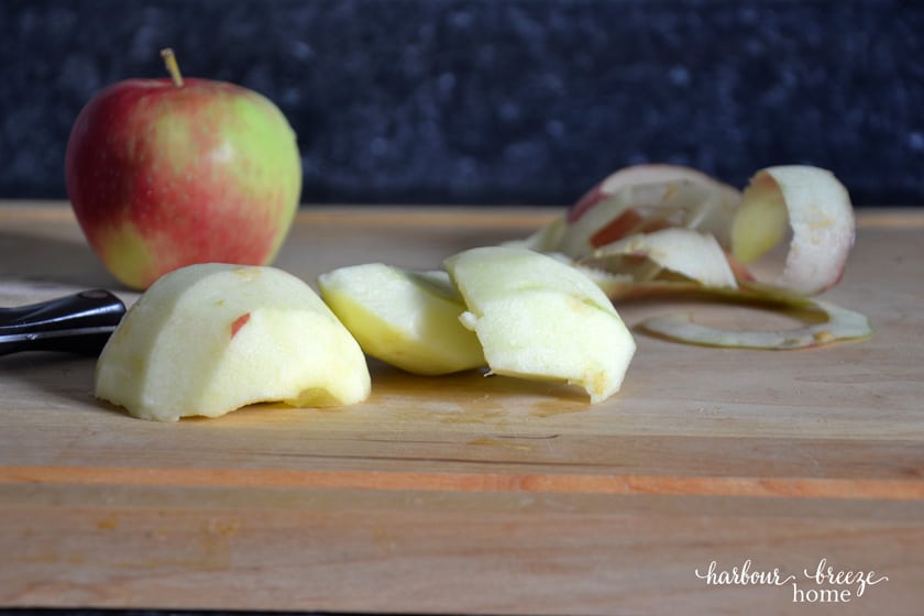 peeled apple chunks on a cutting board