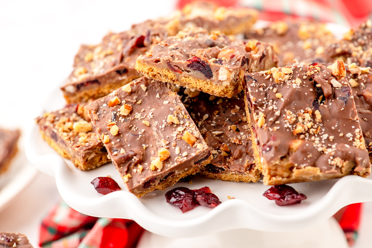 A platter of graham cracker toffee bars with almonds and craisens