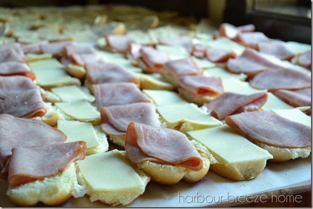 ham and cheese layered on buns for ham and cheese sliders