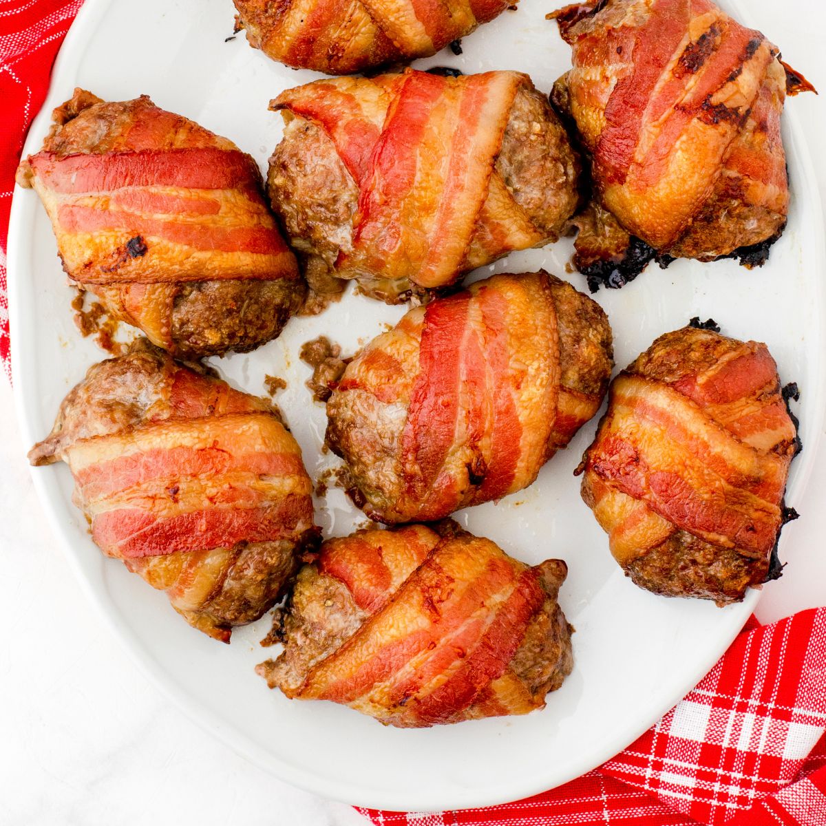 A platter of bacon wrapped mini meatloaf