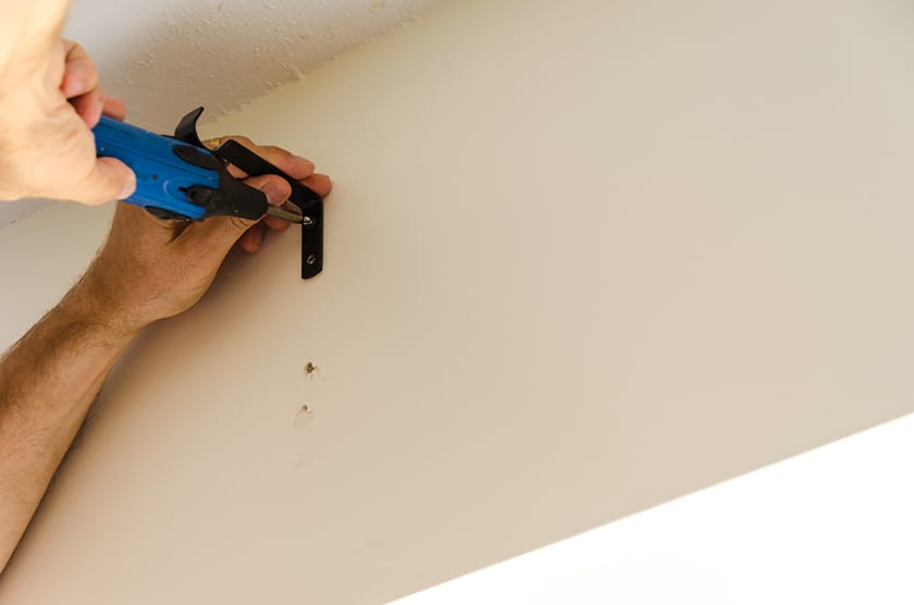 screwing in a curtain rod bracket