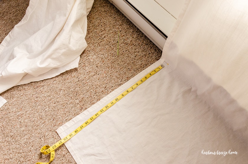 Measuring Ikea curtains before cutting them to hem them.