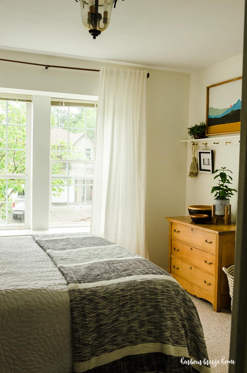 Ikea Curtains hung on copper looking rods in a bedroom