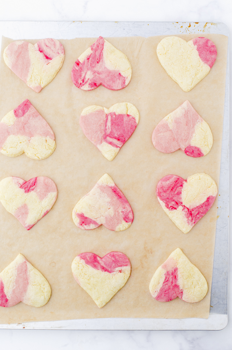 A pan of baked heart sugar cookies.