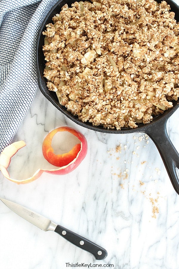 homestyle gathering 3 apple peel and skillet with oatmeal apple crisp inside on white cloth