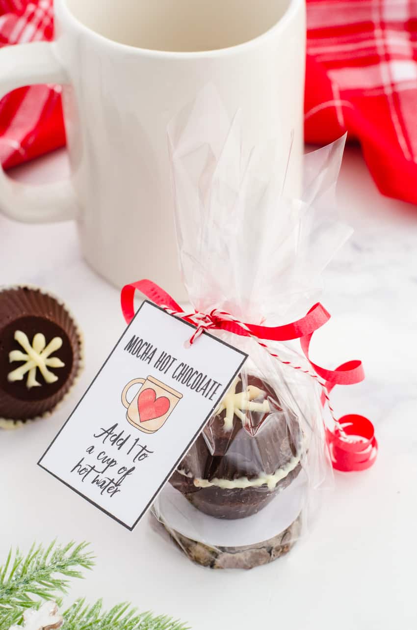 Chocolate Bomb Recipe turned into a Christmas gift by wrapping it individually with cellophane and tying with a printable gift tag for mocha hot chocolate bomb