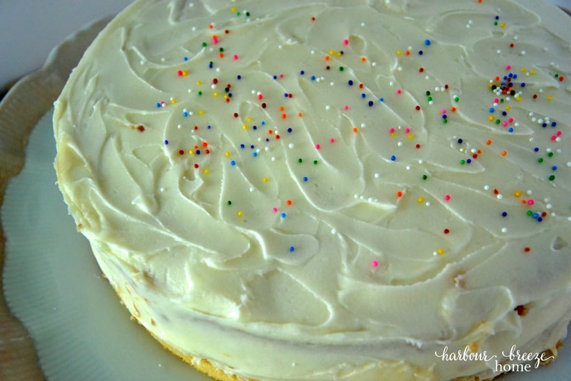A stacked cake with multi-colored sprinkles.