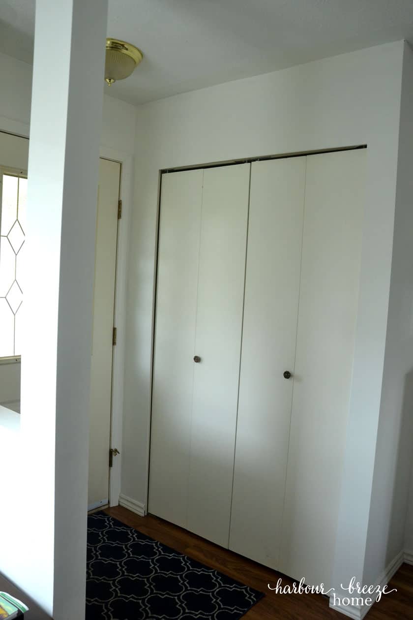 convert bi-fold closet doors into modern farmhouse french doors - The builder grade bi-folding closet doors in a townhouse entryway