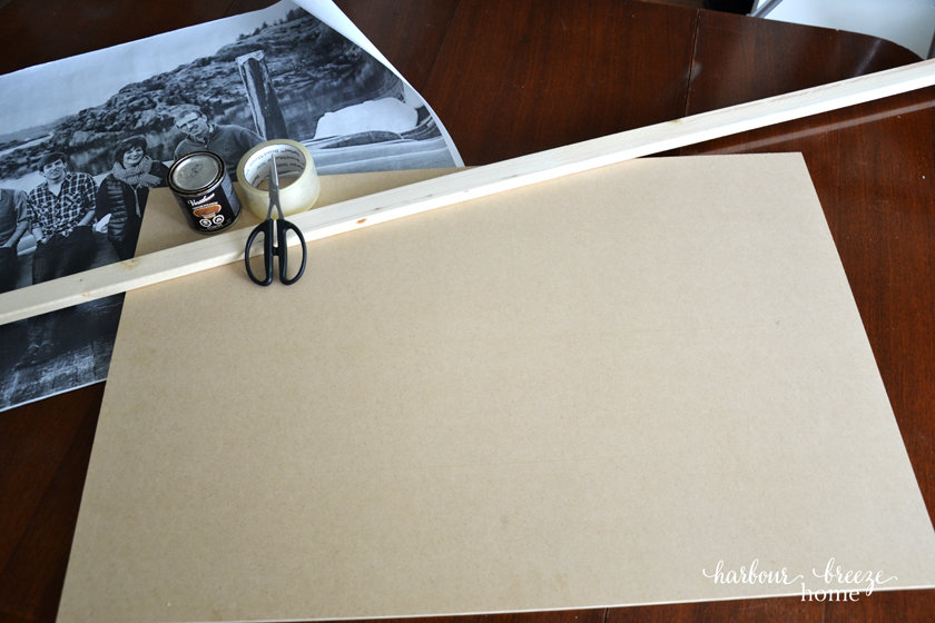 an engineer print, scissors, tape and wood laying on a table