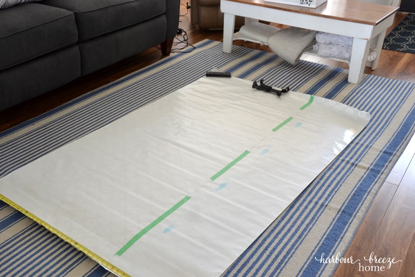 Pieces of a roll of wrapping paper taped together to make one large sheet of paper that will become a gallery wall template.