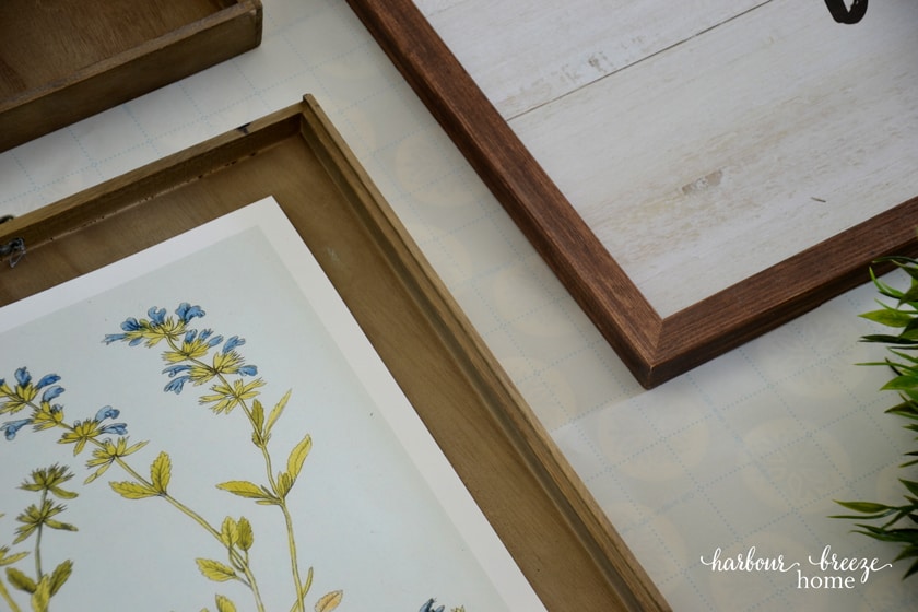 Pictures lined up on the grids of the wrapping paper gallery wall template to ensure they are straight.
