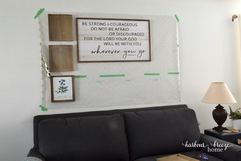 half of the pictures of a gallery wall hung on top of the gallery wall template