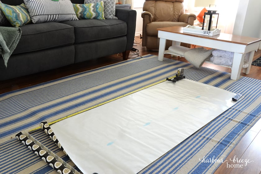 a large roll of paper laid out on the floor that will become a gallery wall template