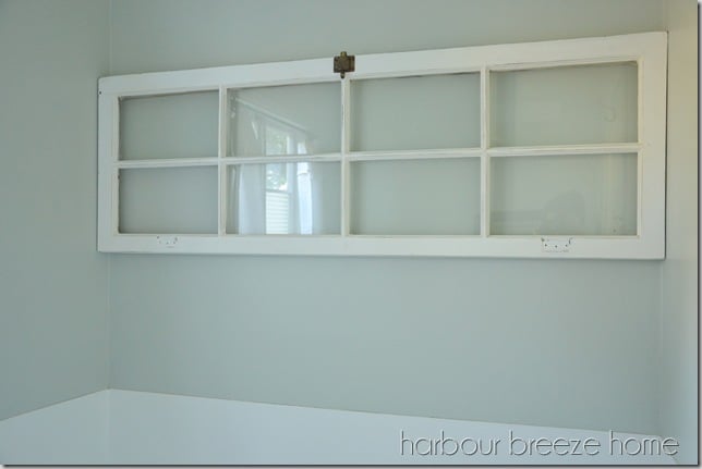 and old window hung on a wall using a french cleat hanging system
