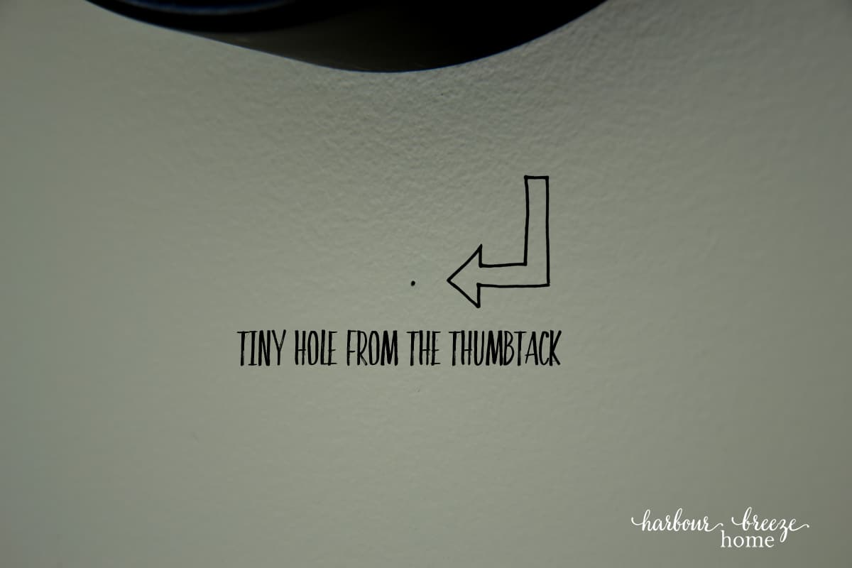 Tiny hole in the wall marking where the nail should go (how to hang a picture on the wall)