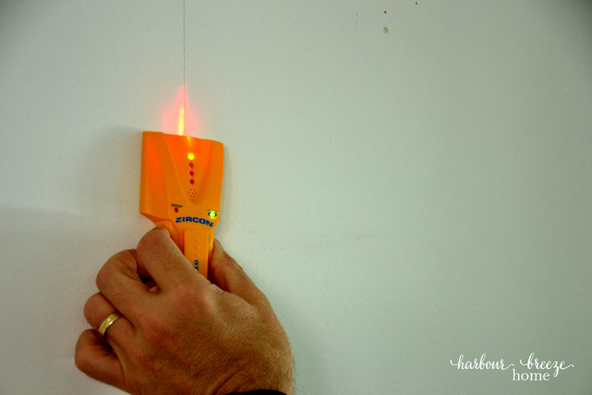 Finding the wall stud in preparation for installing a DIY Shiplap Wall Treatment