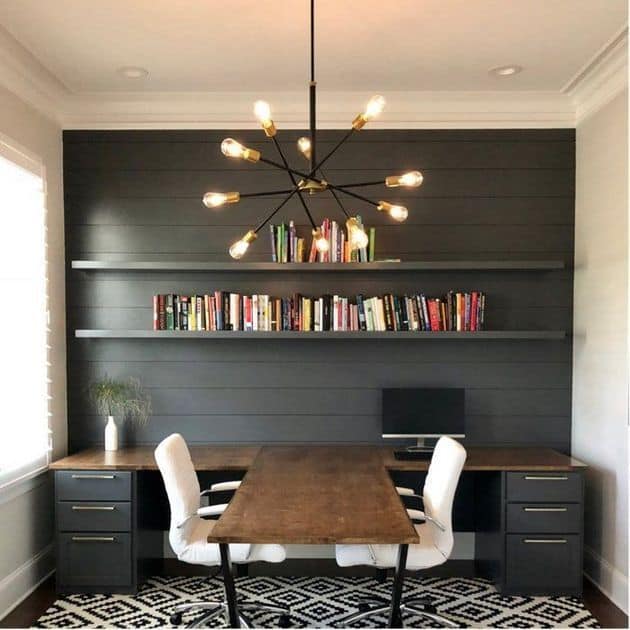 Small room with hanging floating shelves above a desk.