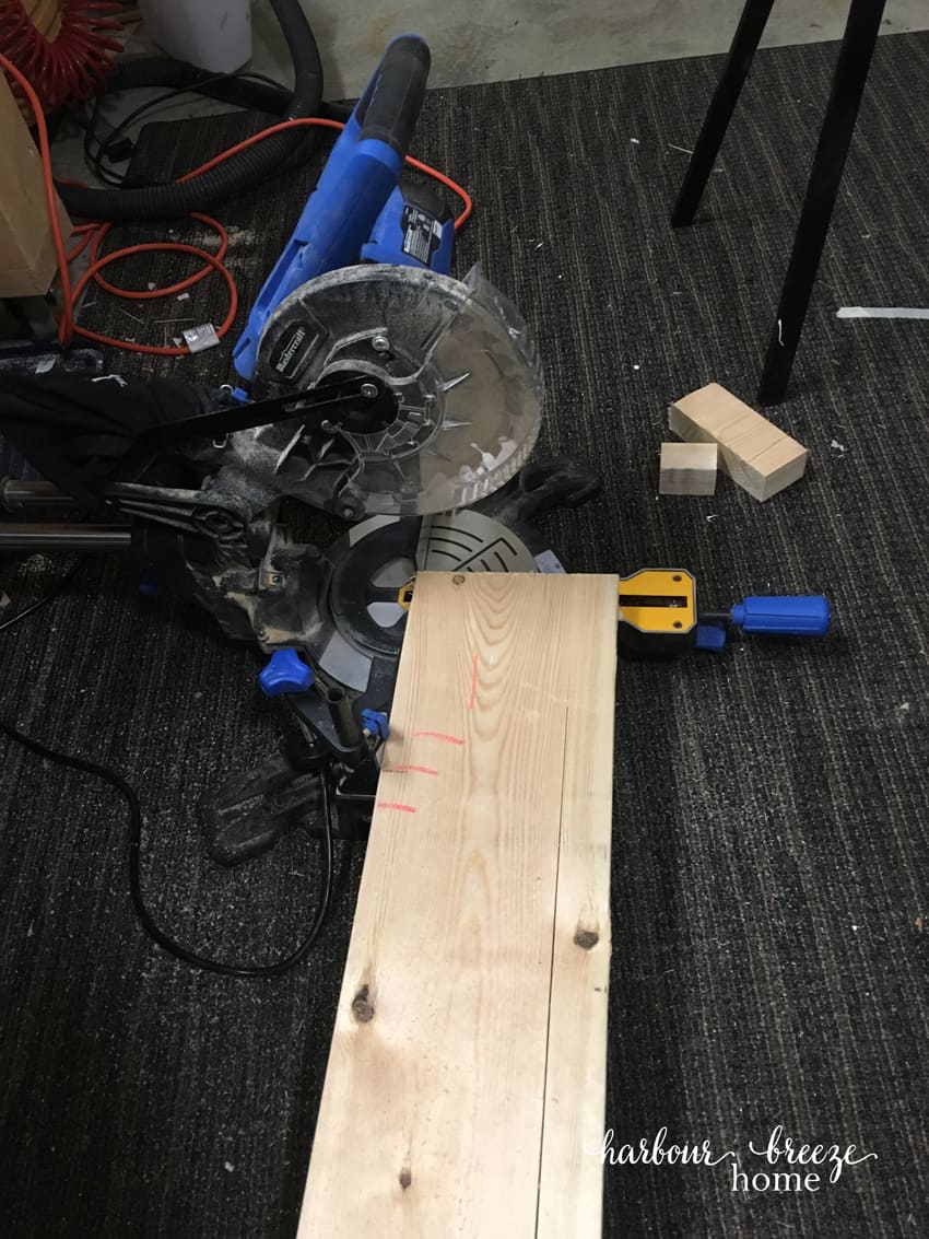 Saw cutting the ends of a board for floating shelves.
