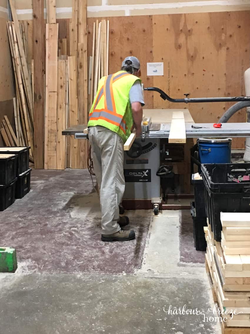 Man cutting boards for DIY floating shelves.